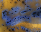 Areas of blue, with black centers, on a yellow background The process of sublimation is quite dynamic on Mars, creating a zoo of spots, streaks and haloes. An informally named area called “Inca City” provides a snapshot of spectacular natural phenomena in early spring; this area looks very different at other times.